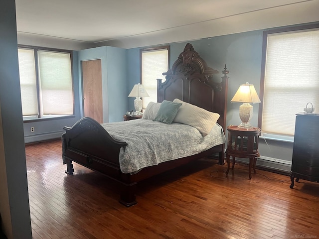 bedroom featuring hardwood / wood-style floors and multiple windows