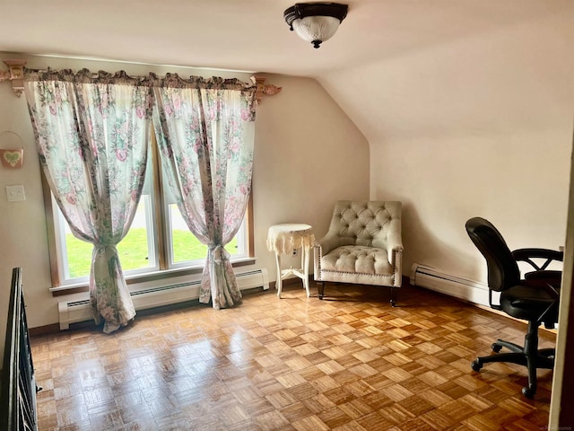 office area with a baseboard radiator, lofted ceiling, and light parquet floors