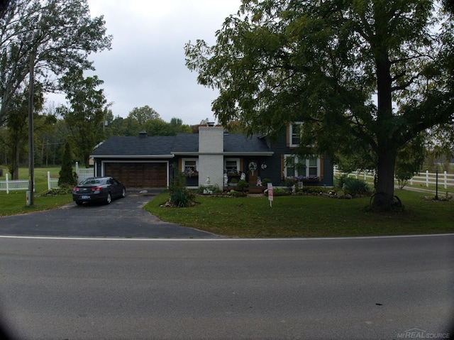 view of front of house with a garage and a front yard