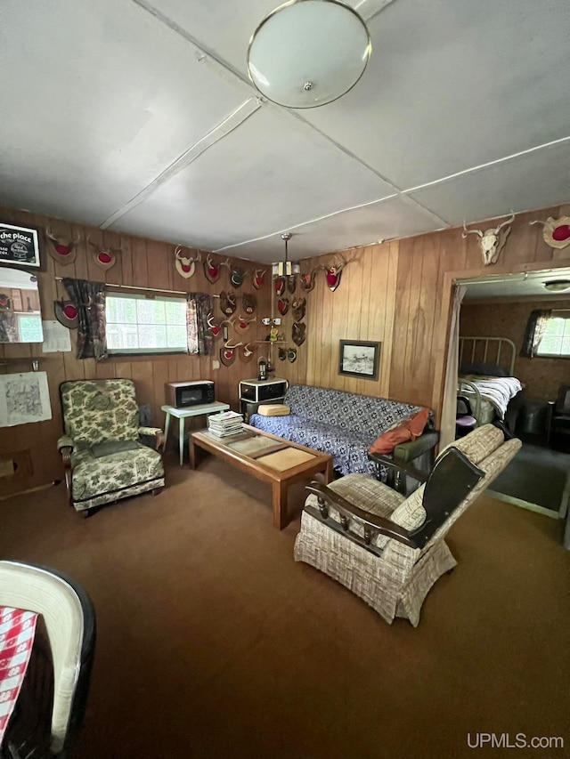 interior space with carpet floors and wooden walls