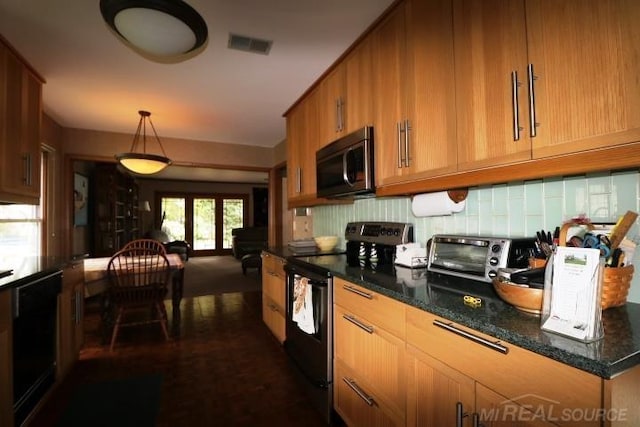 kitchen with dark stone countertops, hanging light fixtures, and black appliances