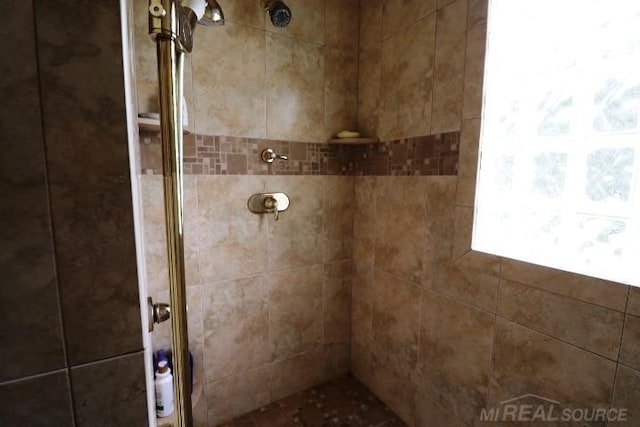 bathroom with tiled shower