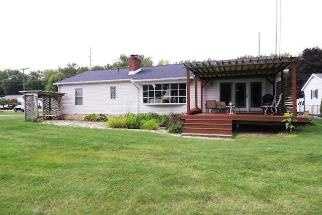 rear view of house with a deck, a yard, and a pergola