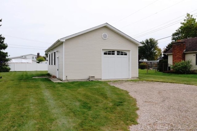 garage featuring a lawn