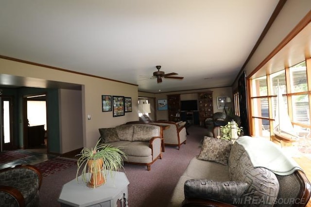 living room with carpet floors, ornamental molding, and ceiling fan