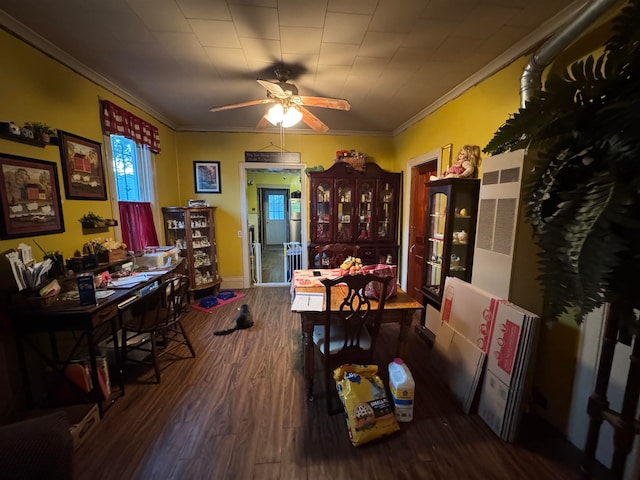 dining space with ceiling fan, crown molding, and dark hardwood / wood-style floors