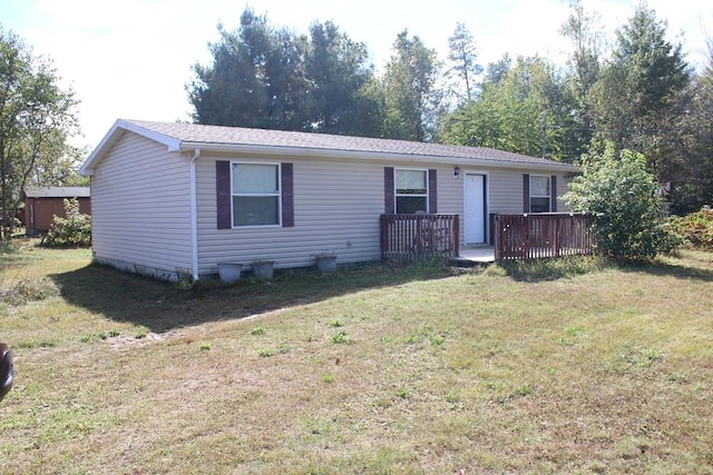 view of front facade featuring a deck and a front lawn