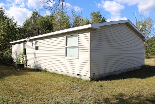 view of side of property with a yard