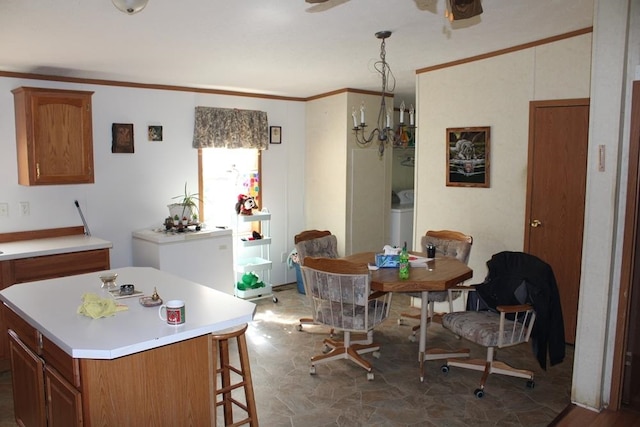 dining area with washer / dryer and ornamental molding