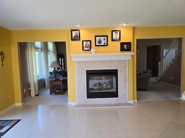 unfurnished living room with a tiled fireplace