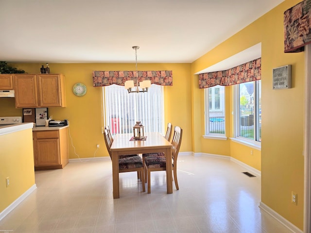 dining space featuring a notable chandelier