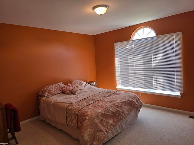 bedroom featuring light carpet