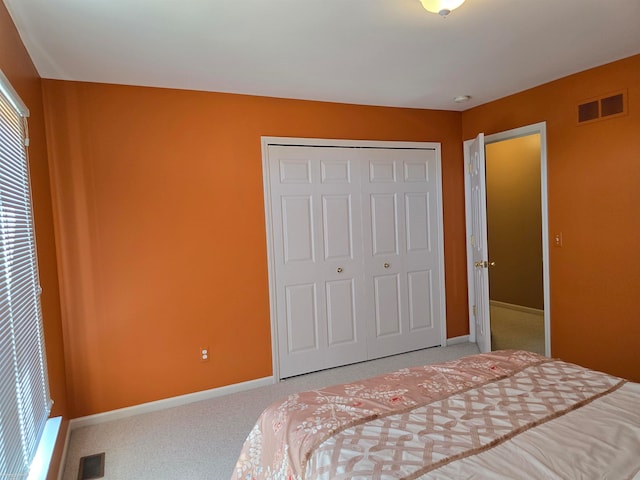 bedroom featuring carpet and a closet