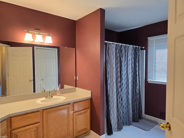 bathroom with vanity, a shower with shower curtain, and tile patterned floors