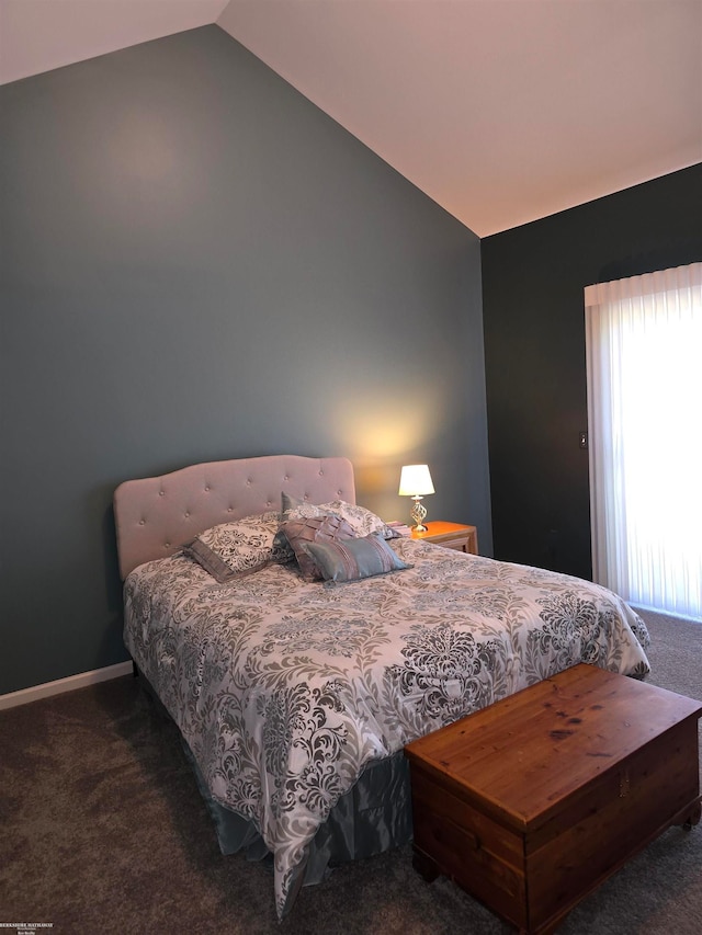 carpeted bedroom with lofted ceiling