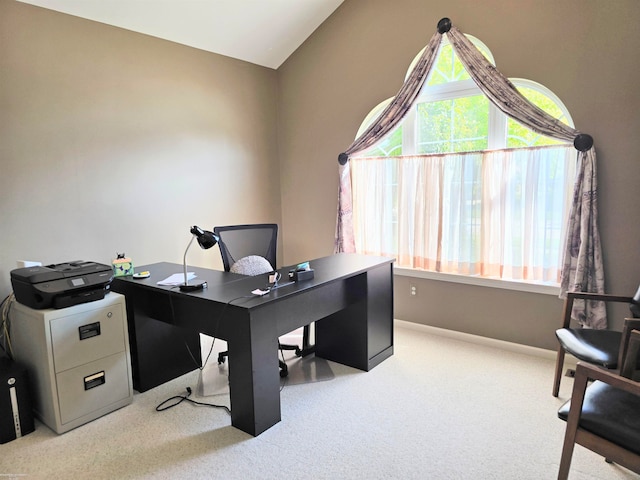 carpeted office space featuring lofted ceiling