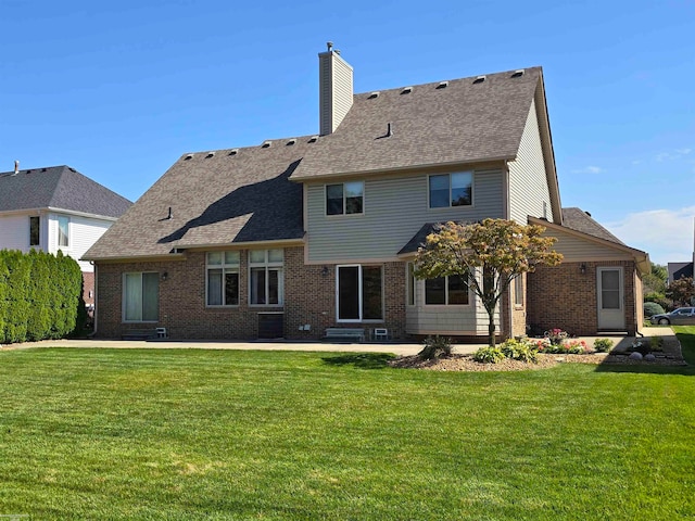 rear view of property featuring a lawn, a patio, and central AC unit