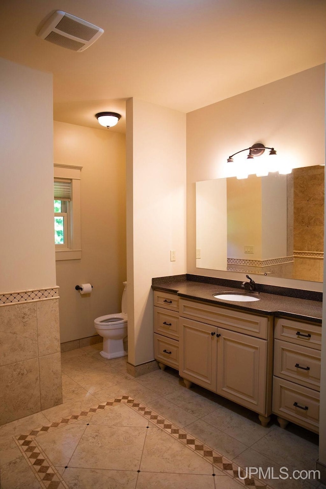 bathroom featuring vanity, toilet, and tile patterned floors