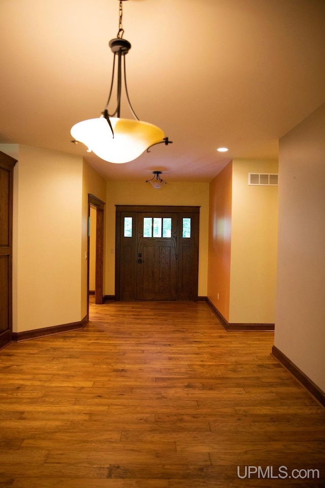 foyer entrance with hardwood / wood-style flooring