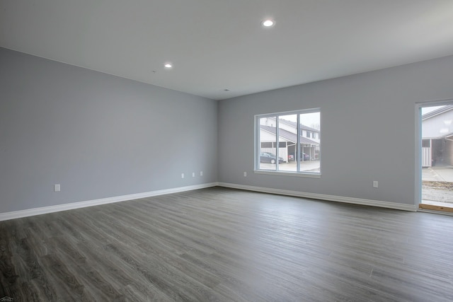 unfurnished room with dark hardwood / wood-style flooring