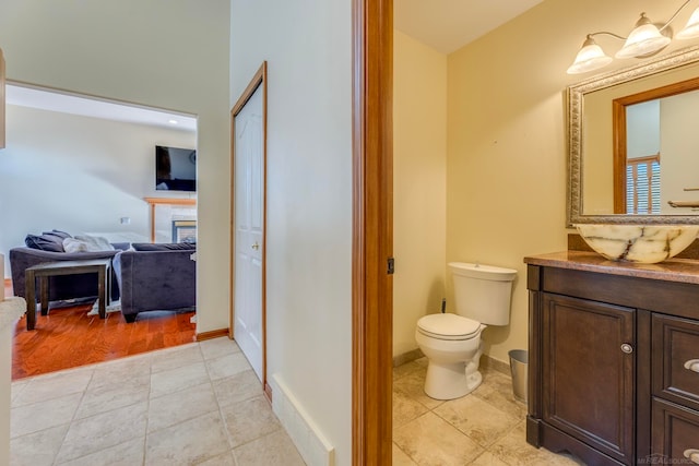 bathroom featuring hardwood / wood-style floors, vanity, and toilet