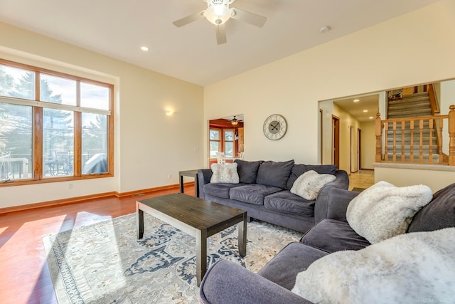 living room with ceiling fan and light hardwood / wood-style flooring