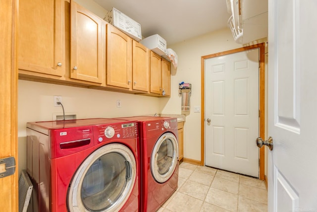 washroom with separate washer and dryer, light tile patterned flooring, and cabinets