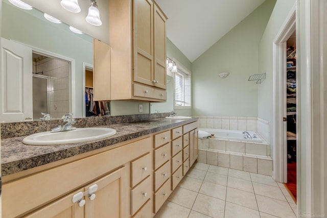 bathroom with tile patterned flooring, vanity, vaulted ceiling, and plus walk in shower