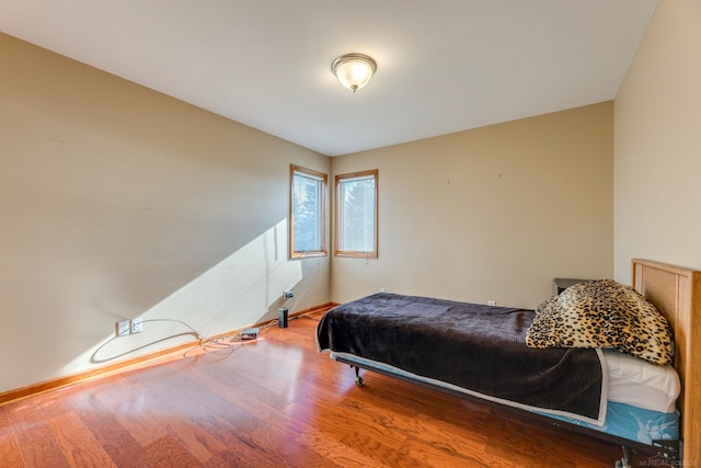 bedroom with hardwood / wood-style flooring