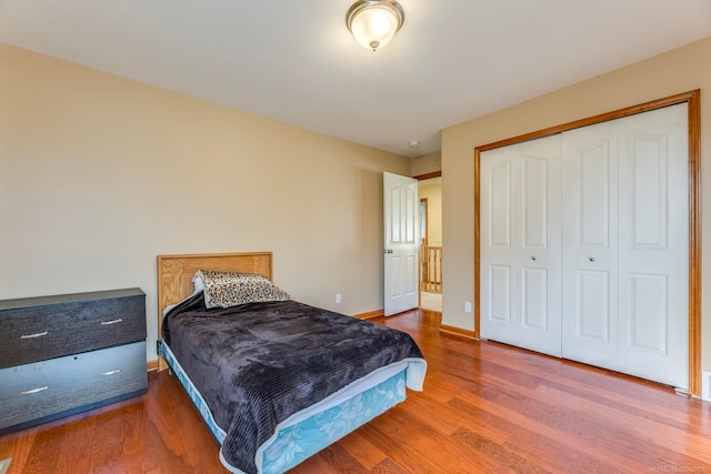 bedroom with wood-type flooring and a closet