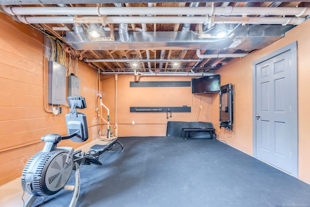 exercise area with concrete flooring and electric panel