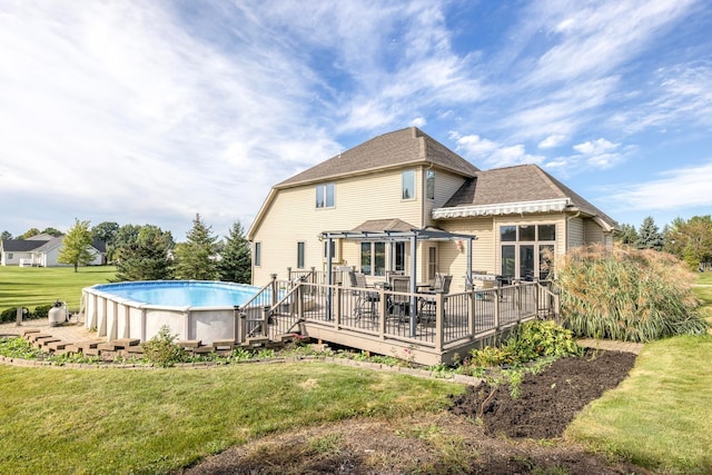 back of house featuring a pool side deck and a lawn