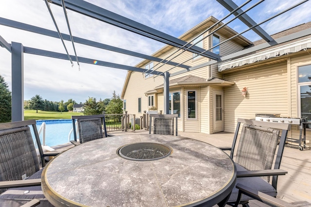 view of patio / terrace featuring a pool side deck and a fire pit