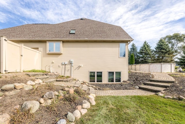 rear view of house featuring a yard