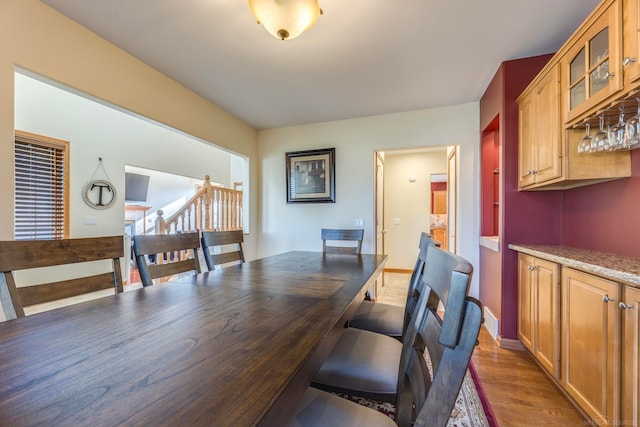 dining space featuring bar area and dark hardwood / wood-style flooring