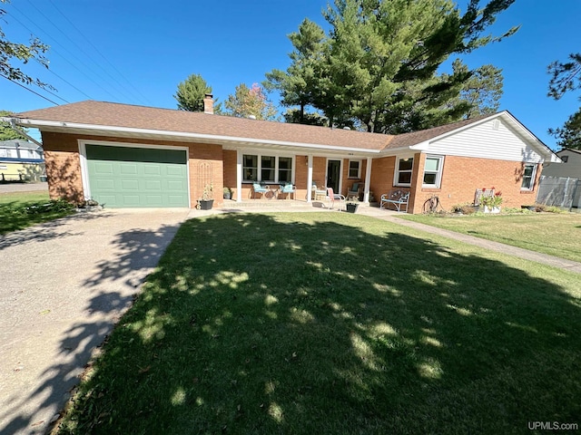 single story home with a front lawn, a porch, and a garage