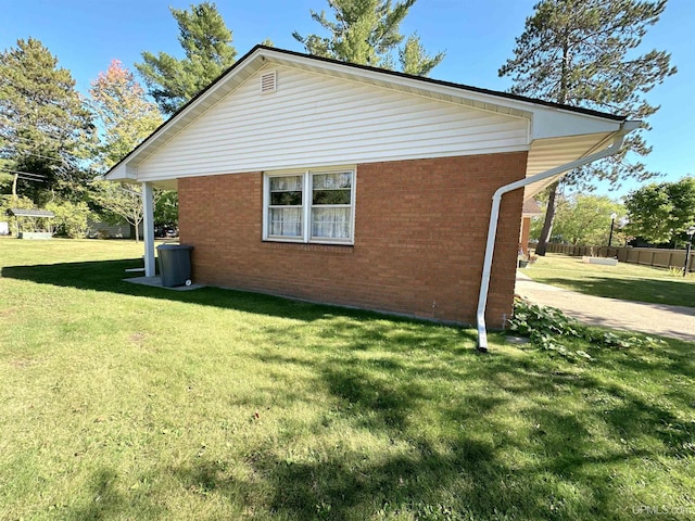 view of side of property with a lawn