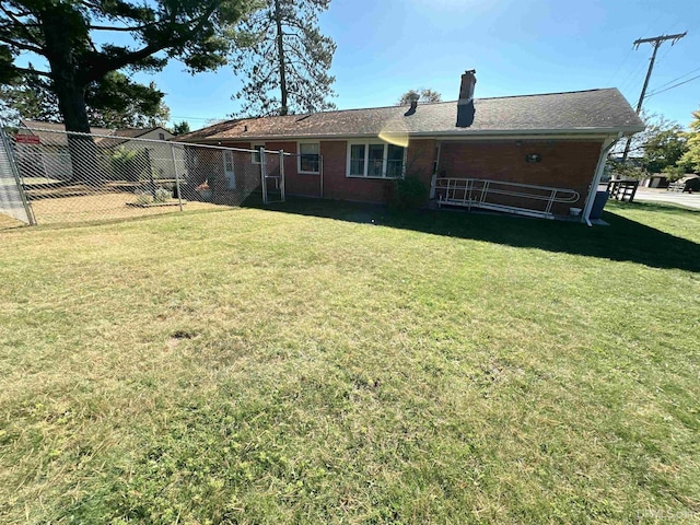 back of house featuring a lawn