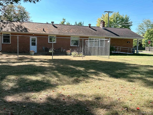 rear view of house featuring a lawn