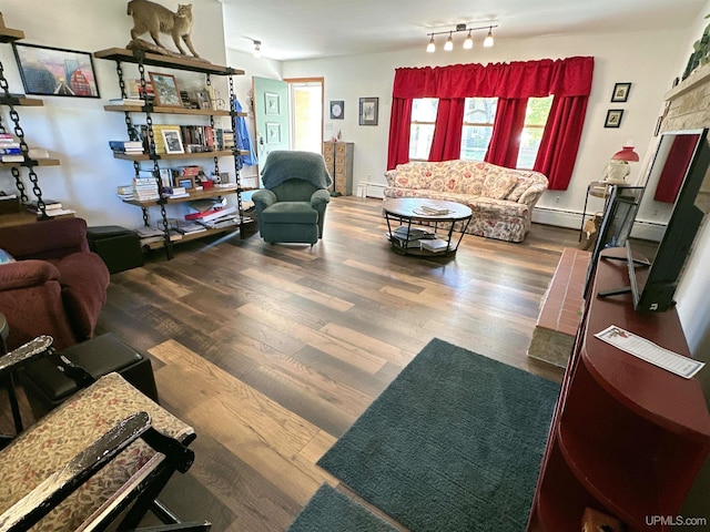 living room featuring dark hardwood / wood-style floors and a baseboard heating unit