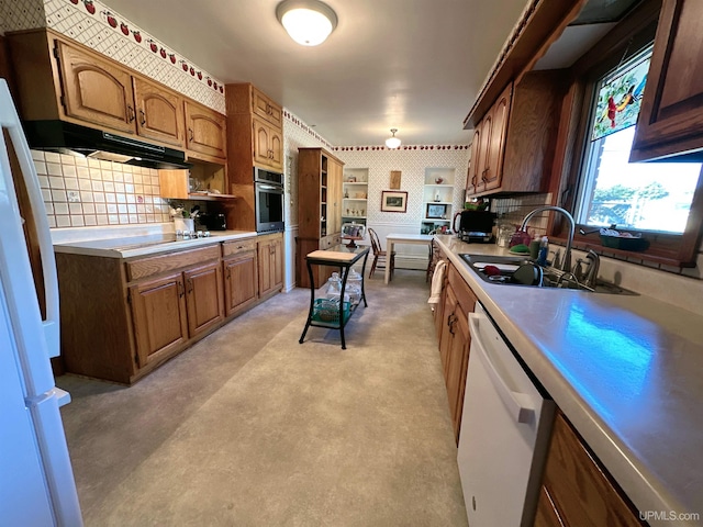 kitchen with sink, white appliances, and tasteful backsplash