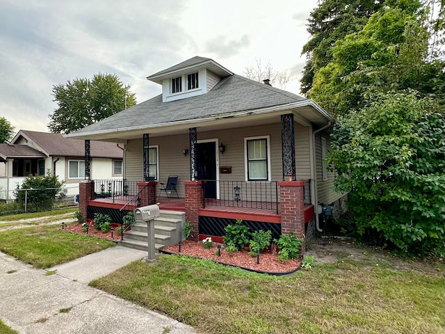 view of front of house with a porch and a front lawn