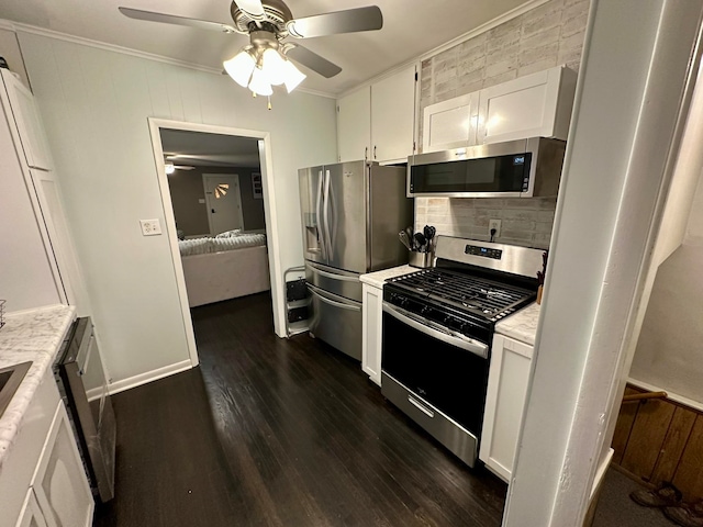 kitchen featuring ceiling fan, backsplash, dark wood-type flooring, white cabinetry, and appliances with stainless steel finishes