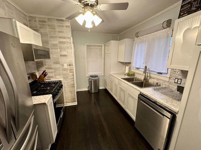 kitchen with sink, white cabinets, appliances with stainless steel finishes, dark hardwood / wood-style flooring, and ceiling fan