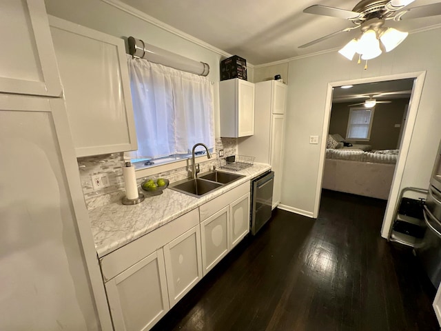 kitchen with white cabinetry, dishwasher, dark hardwood / wood-style flooring, ceiling fan, and sink