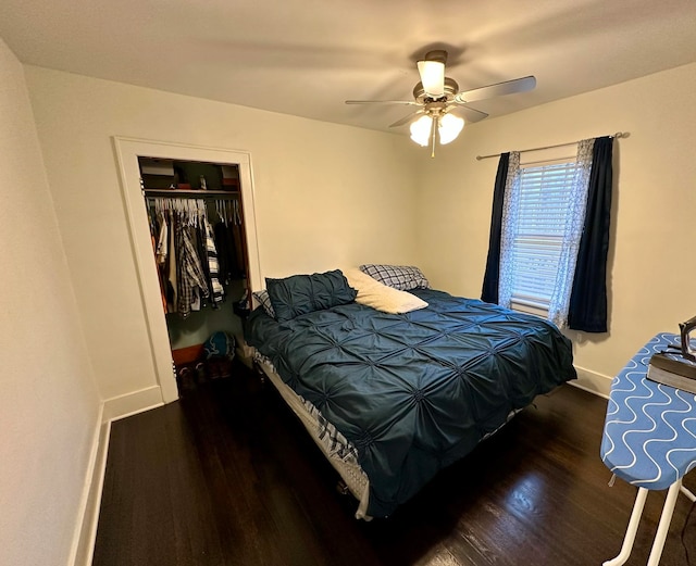 bedroom featuring dark hardwood / wood-style flooring, ceiling fan, and a closet