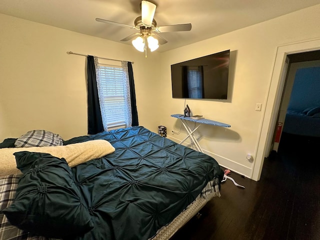 bedroom with ceiling fan and dark hardwood / wood-style flooring