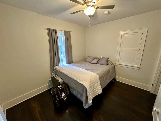 bedroom featuring ceiling fan and dark wood-type flooring