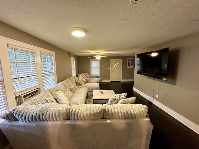 living room with ceiling fan and a textured ceiling