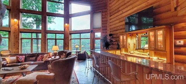 living room featuring a high ceiling and a wealth of natural light